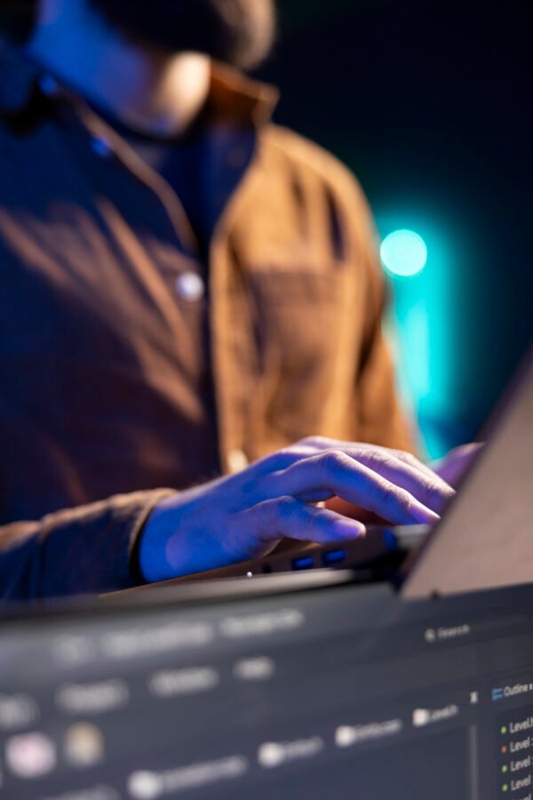 it admin in apartment fixing coding issues using laptop, close up